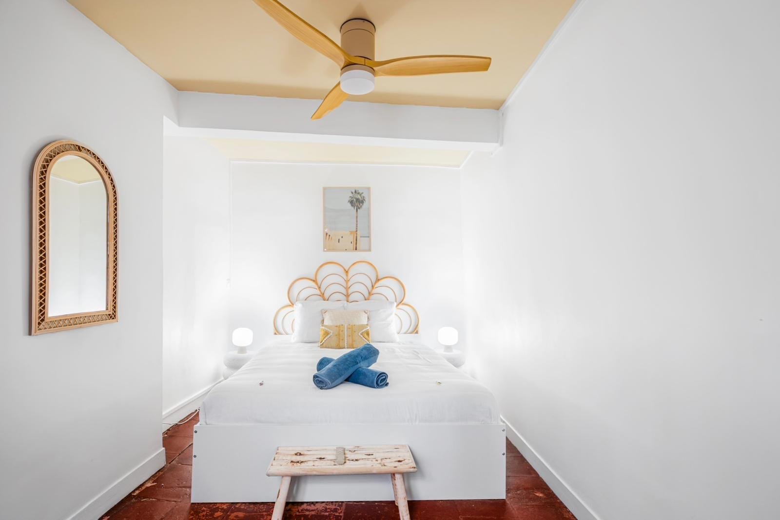 Chambre blanche épurée avec tête de lit en rotin